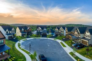 Aerial sunset panoramic view of newly built high end luxury single family alp style house community at Lake Linganore Oakdale surrounding a cul-de-sac neighborhood street in Maryland USA