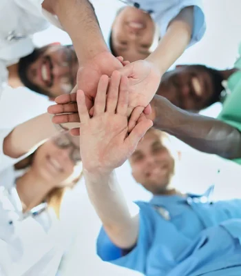 GROUP OF MULTINATIONAL INTERNS LOOKING DOWN Smiling