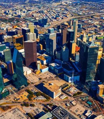 An area of beautiful skyscrapers in the uptown of Dallas, Texas, USA. Vast scenery of the city from top on sunny day.