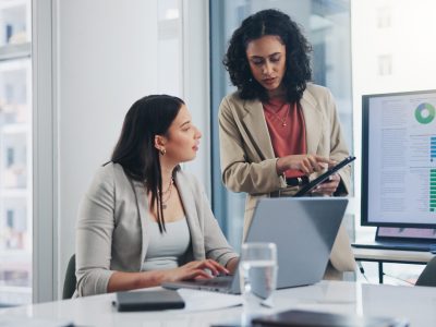 Business meeting, data analytics or women with graph presentation in office for tablet, idea or laptop collaboration. Chart, analysis or accounting team brainstorming economy, inflation or solution.