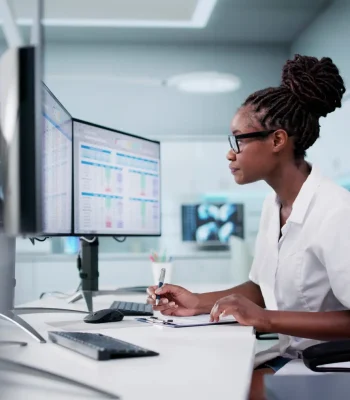 Hospital Doctor Using Spreadsheet For Billing Codes On Desktop